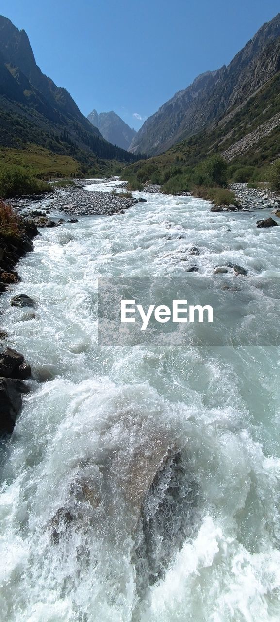 water, scenics - nature, rapid, beauty in nature, mountain, environment, river, nature, landscape, body of water, land, sky, motion, no people, mountain range, rock, travel destinations, travel, sports, clear sky, day, outdoors, non-urban scene, forest, blue, water sports, stream, tourism, flowing water, tranquility, tranquil scene, idyllic, plant, sunny, tree, watercourse