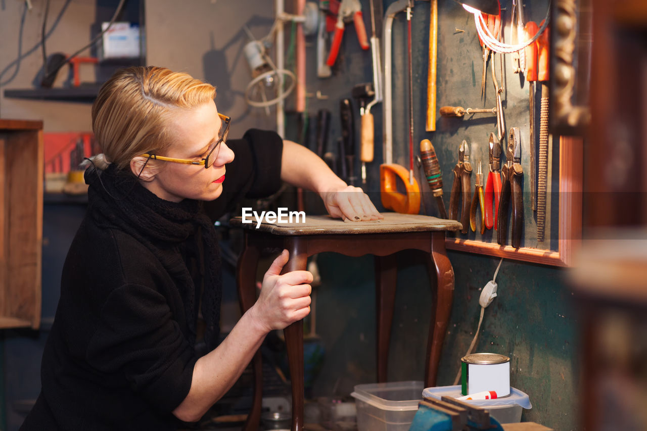 Mature woman in workshop