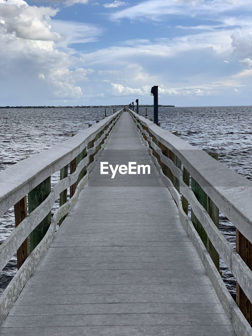 Pier over sea against sky