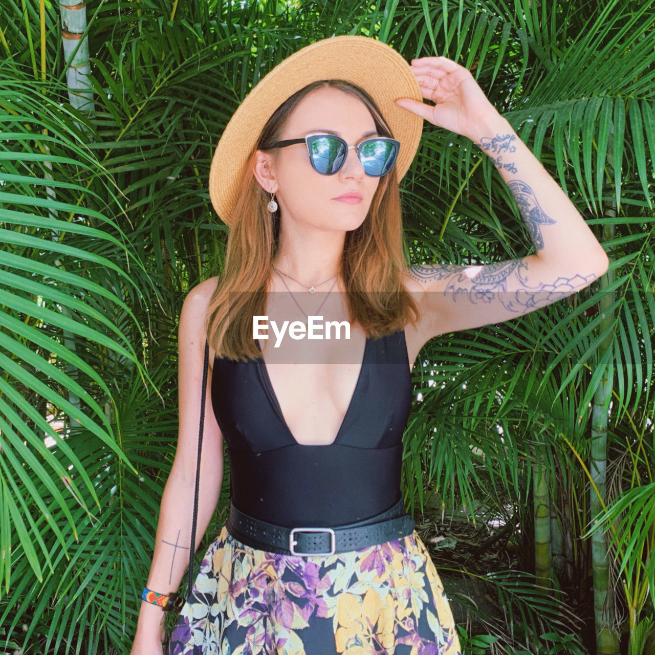 Young woman wearing sunglasses on field