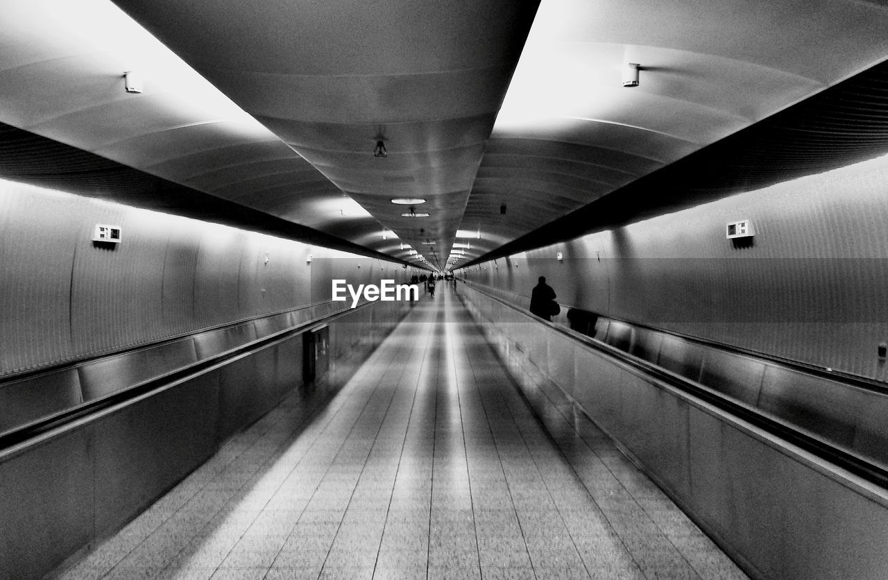 INTERIOR OF ILLUMINATED UNDERGROUND WALKWAY