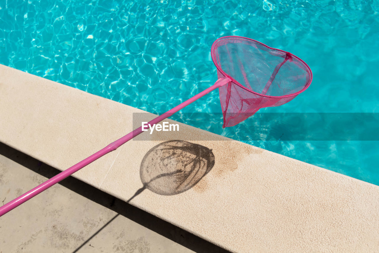 High angle view of butterfly net over swimming pool