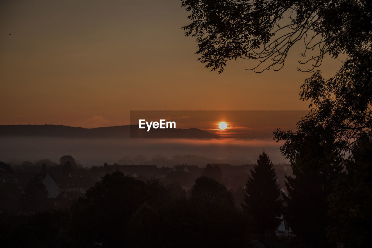 Town against sky during sunrise