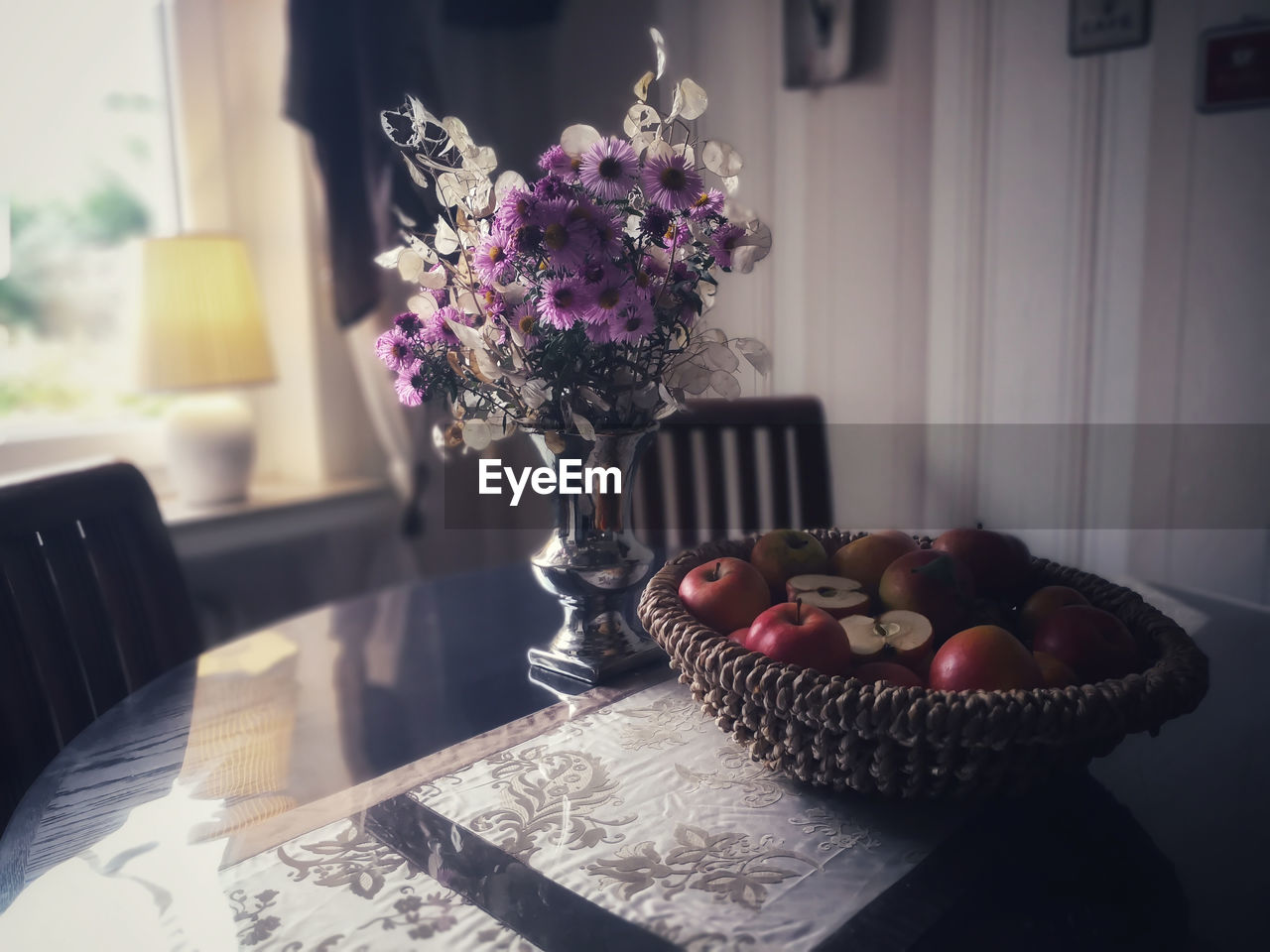 Autumnally decorate with asters, silver leaf lunaria and an old variety of apples. dark furniture