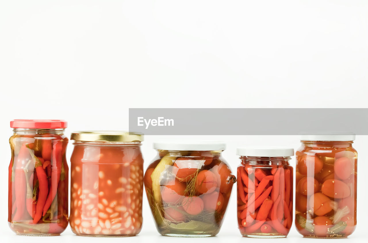 Close-up of glass jar against white background