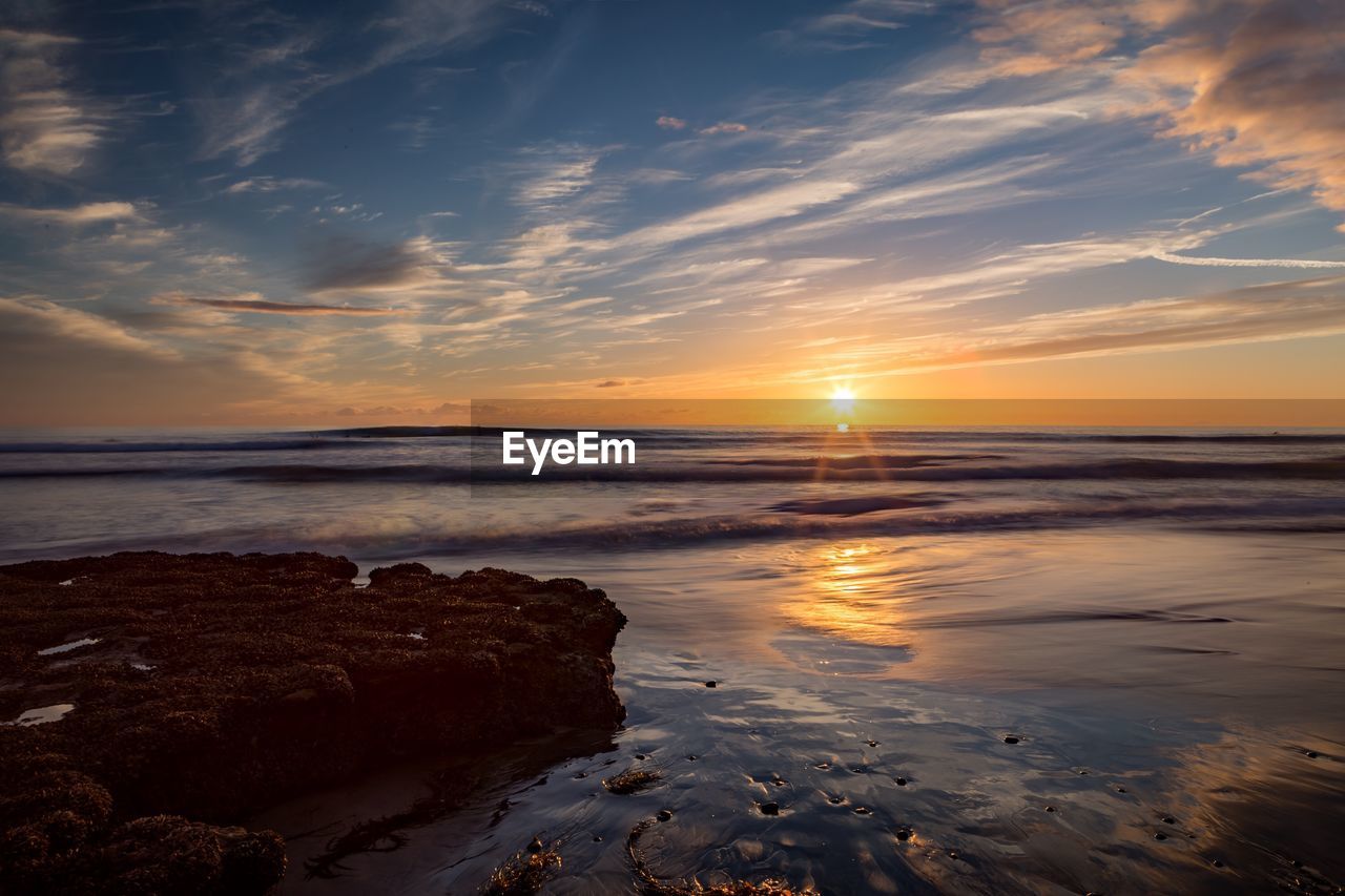 Scenic view of sea against sky during sunset