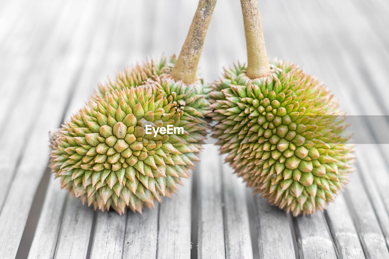 CLOSE-UP OF FRUIT ON TABLE AGAINST WALL