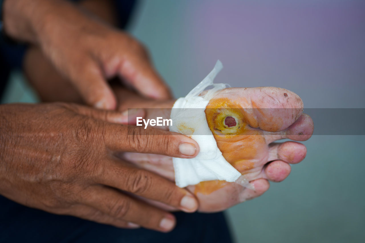 CLOSE-UP OF HANDS HOLDING FISH