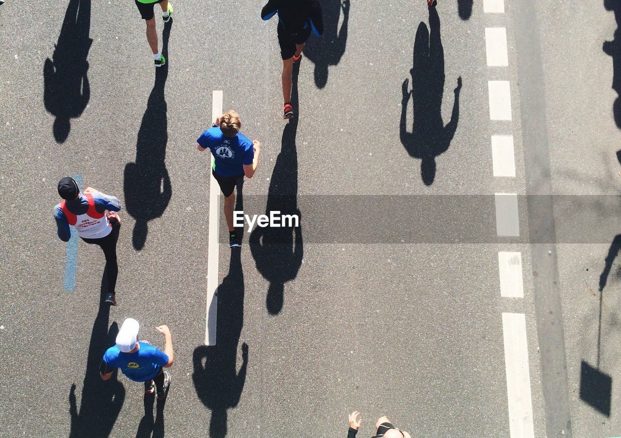 High angle view of athletes running on street during marathon