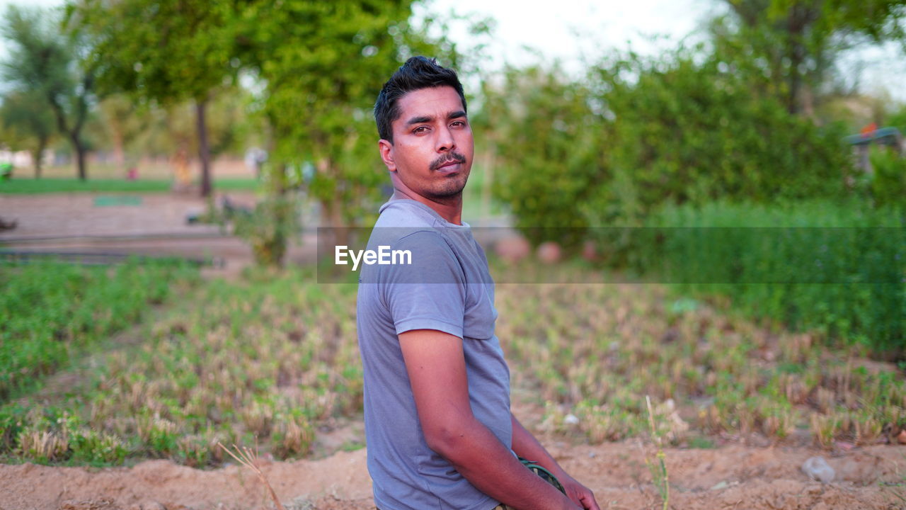 Portrait of young man standing on land