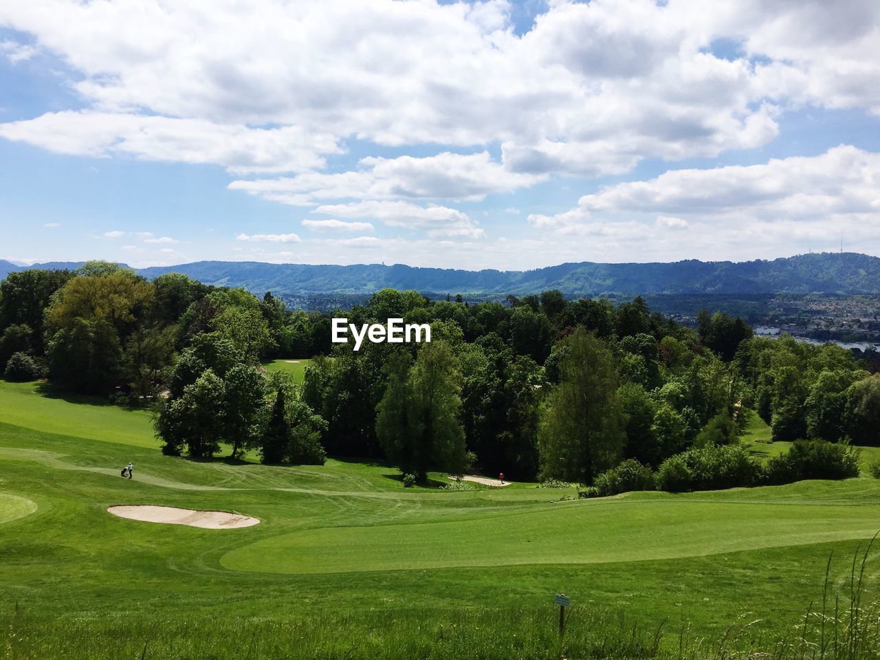 Scenic view of golf course against sky