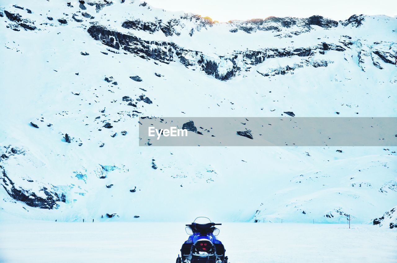 Snowmobile on snow covered mountain