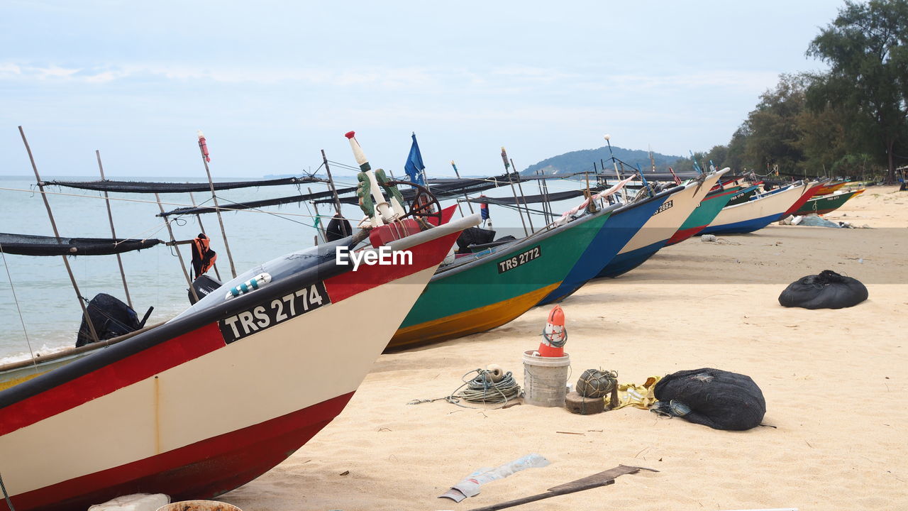 VIEW OF BOATS MOORED ON BEACH