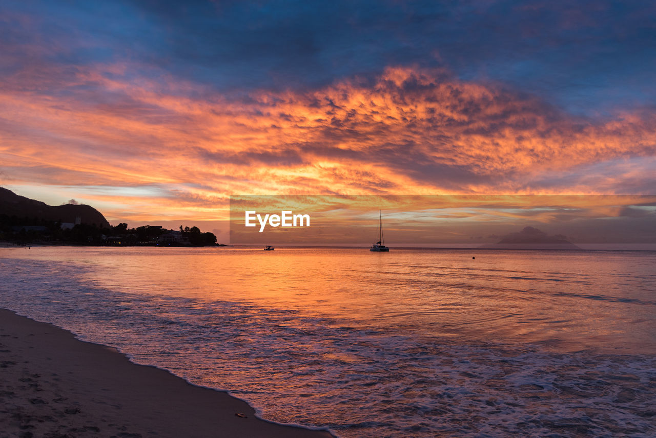 Scenic view of beach against sky during sunset