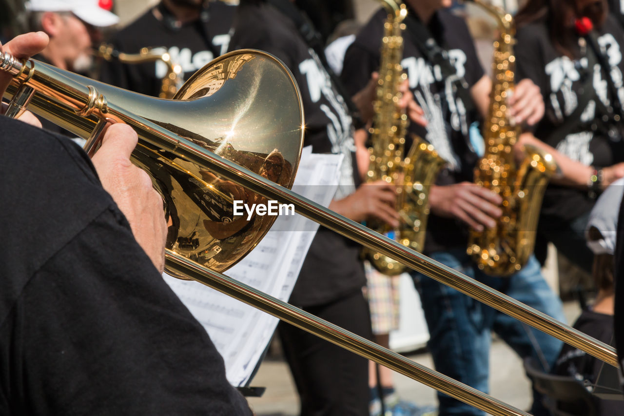 Midsection of man playing trumpet