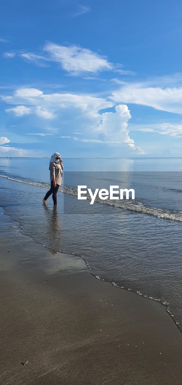 PERSON ON BEACH AGAINST SKY