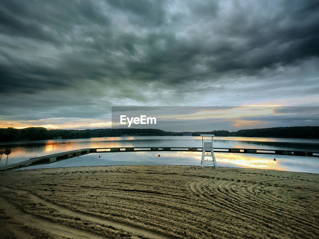 Scenic view of lake against cloudy sky