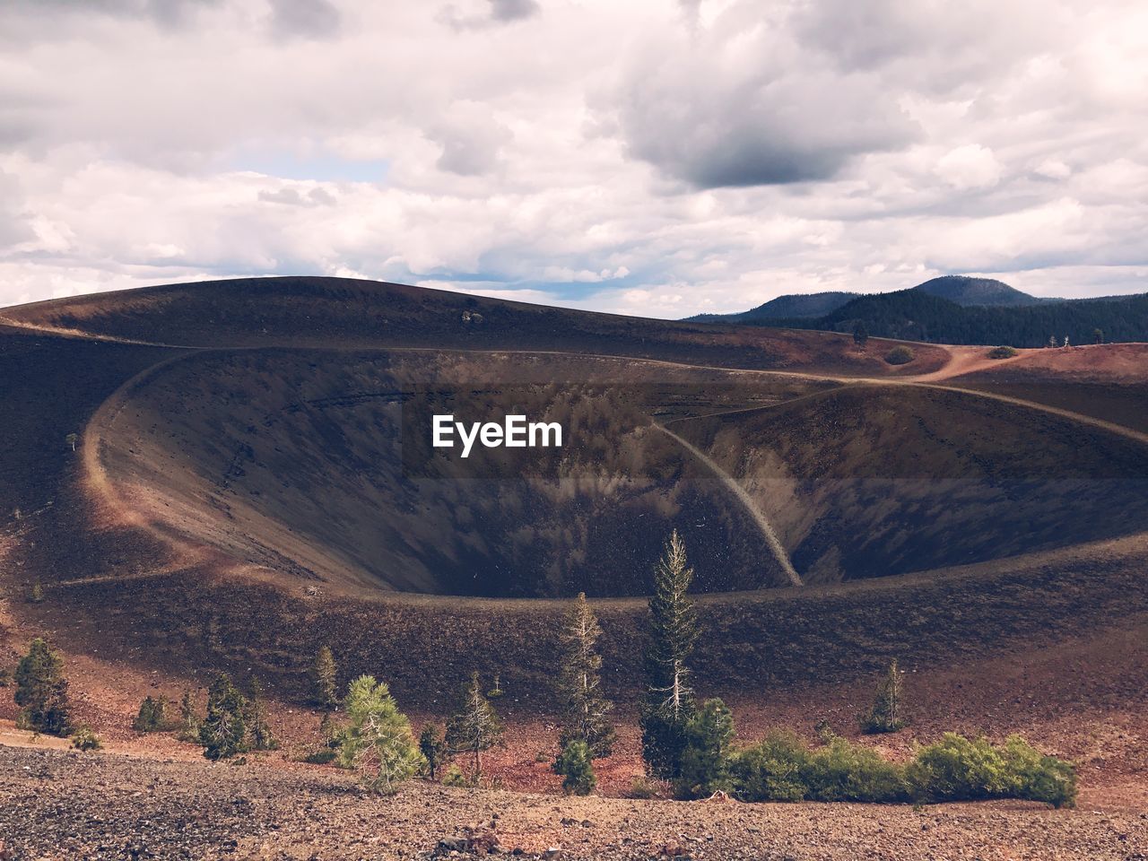 Scenic view of mountain against cloudy sky