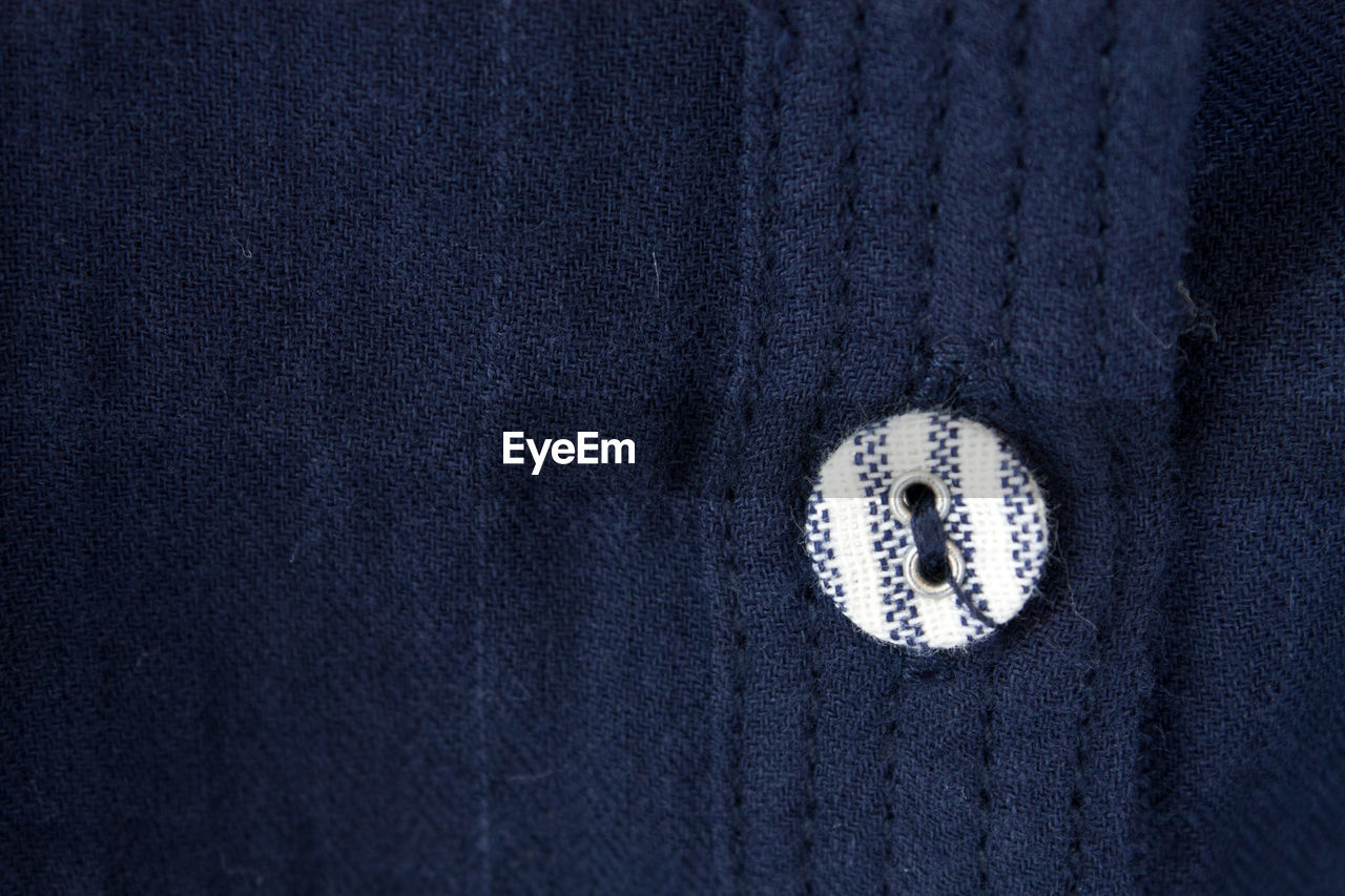 Close-up of button on sweater