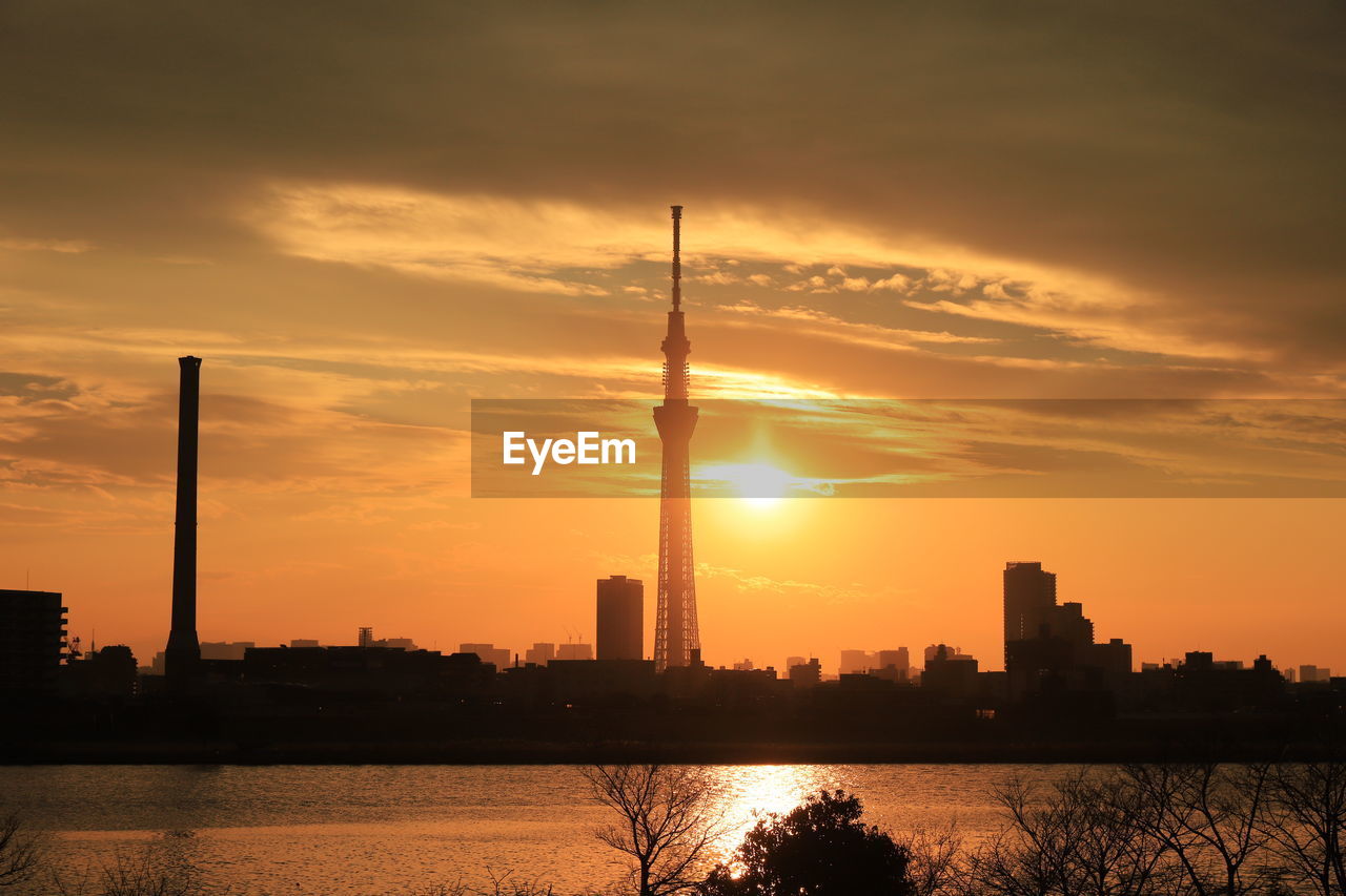 Silhouette of buildings against sky during sunset