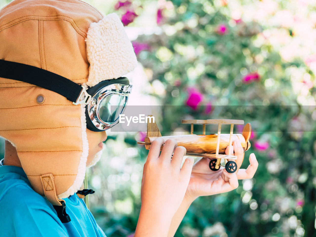 Close-up of boy holding model airplane