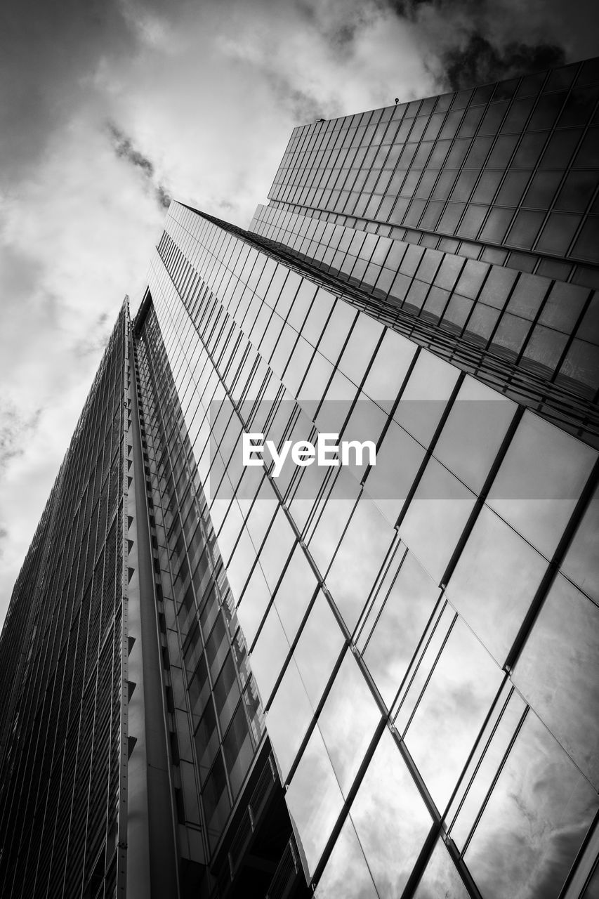 LOW ANGLE VIEW OF GLASS BUILDING AGAINST SKY