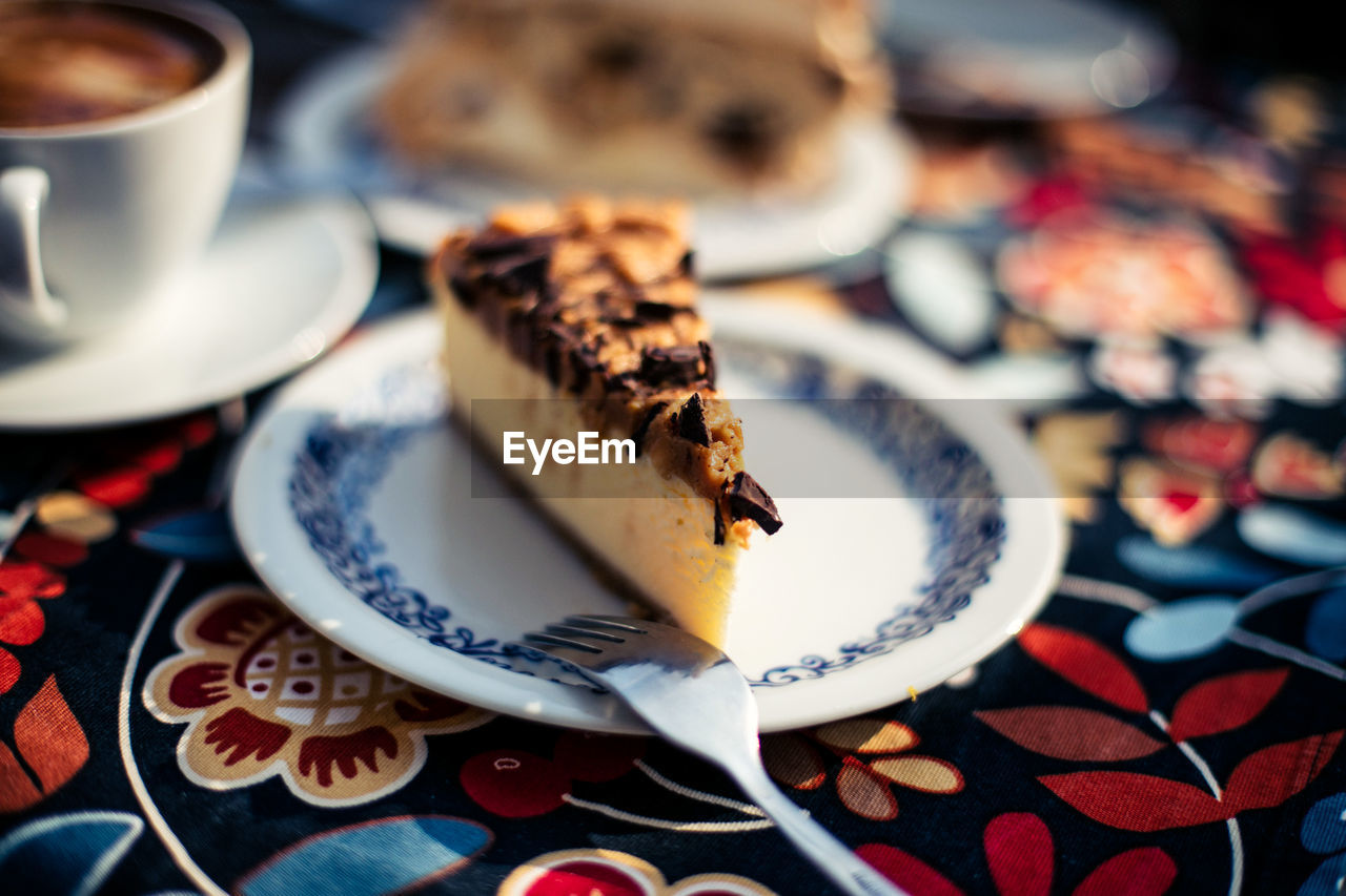 Cheesecake in plate on tablecloth