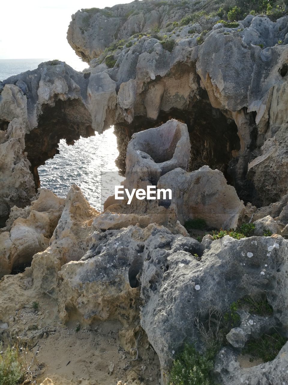 ROCK FORMATION AMIDST WATER