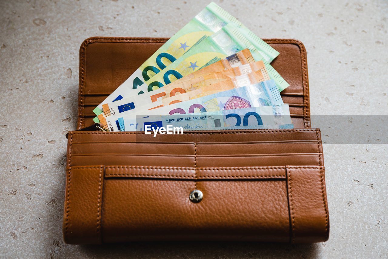 high angle view of paper currency in bag on table