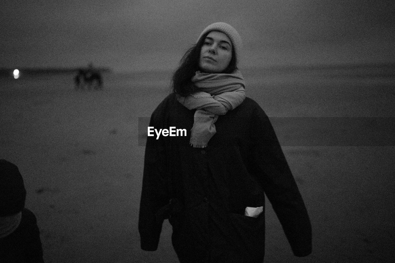 Woman standing at beach during winter