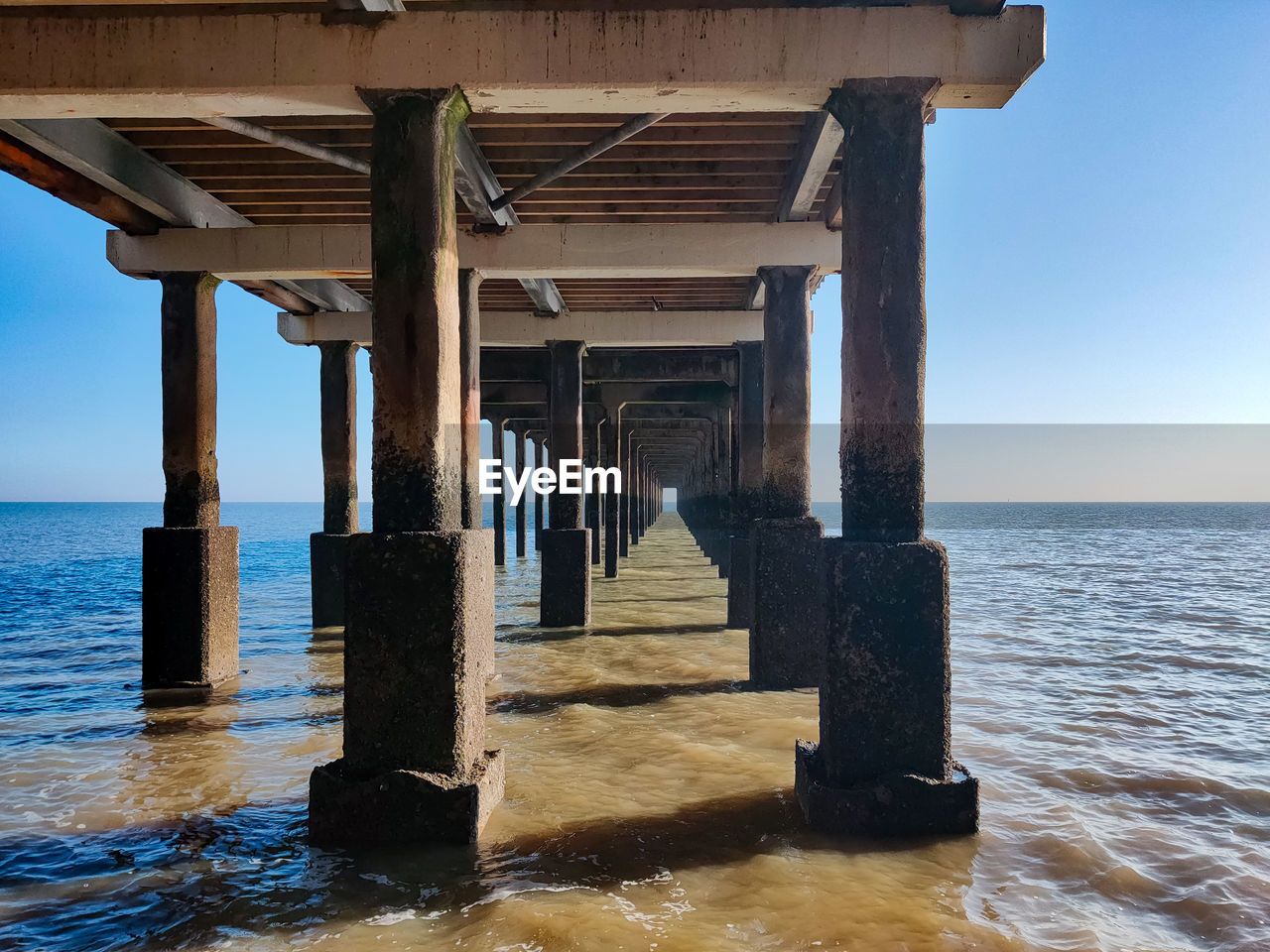 Wooden pier on sea against sky
