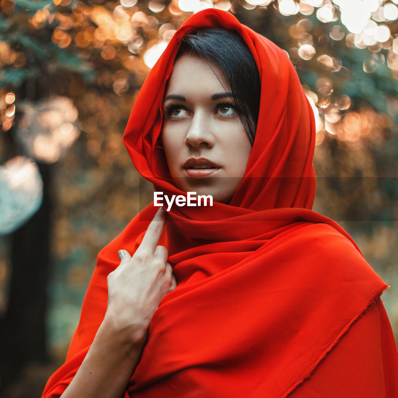 PORTRAIT OF BEAUTIFUL YOUNG WOMAN WITH RED EYES