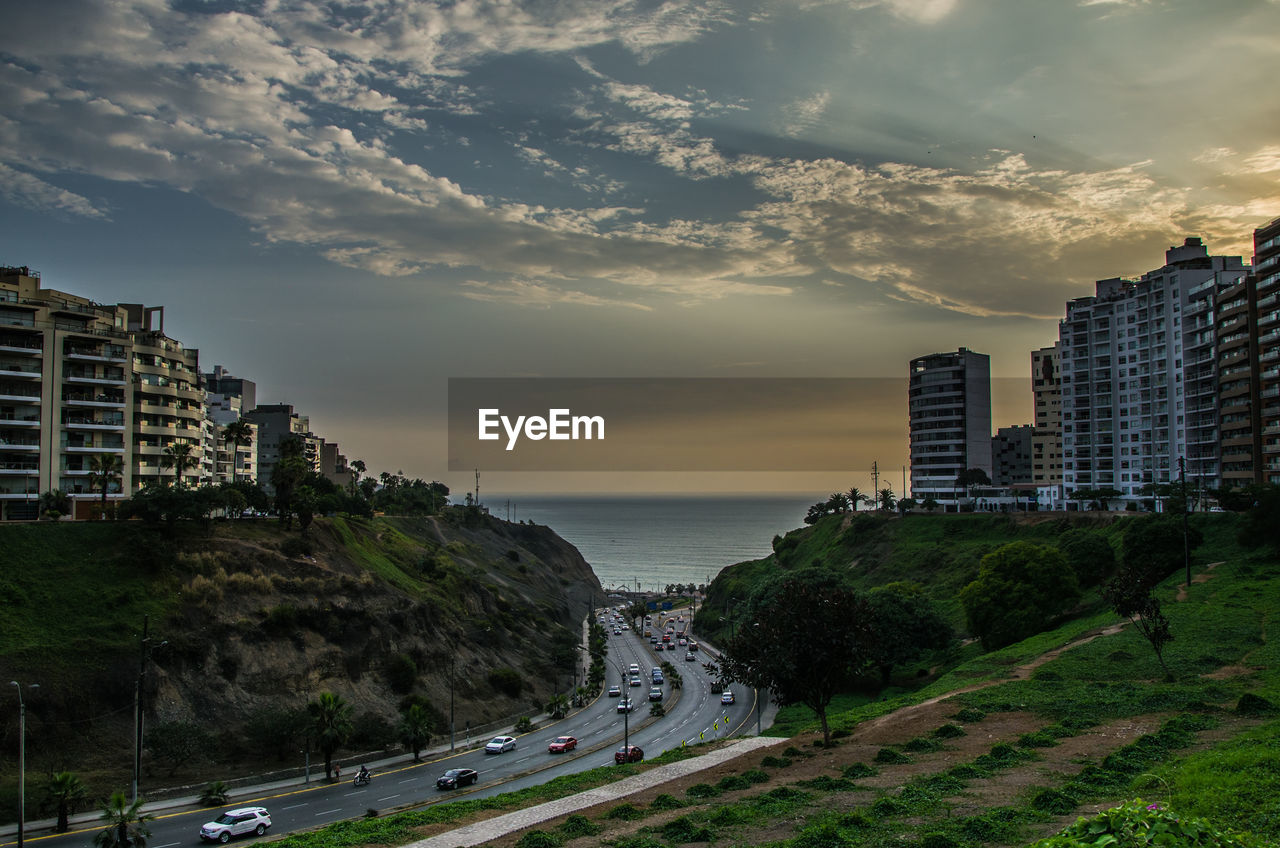 Panoramic view of buildings and sea against sky during sunset