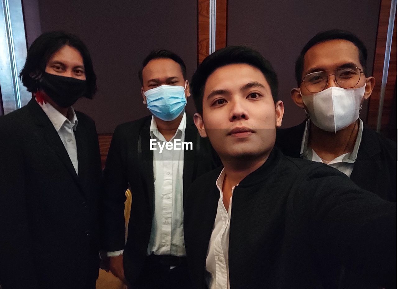 group of people, men, adult, business, human face, clothing, person, glasses, indoors, formal wear, occupation, businessman, healthcare and medicine, coworker, communication, protective mask - workwear, security, portrait, mask, young adult, corporate business, protection, women, disguise, small group of people