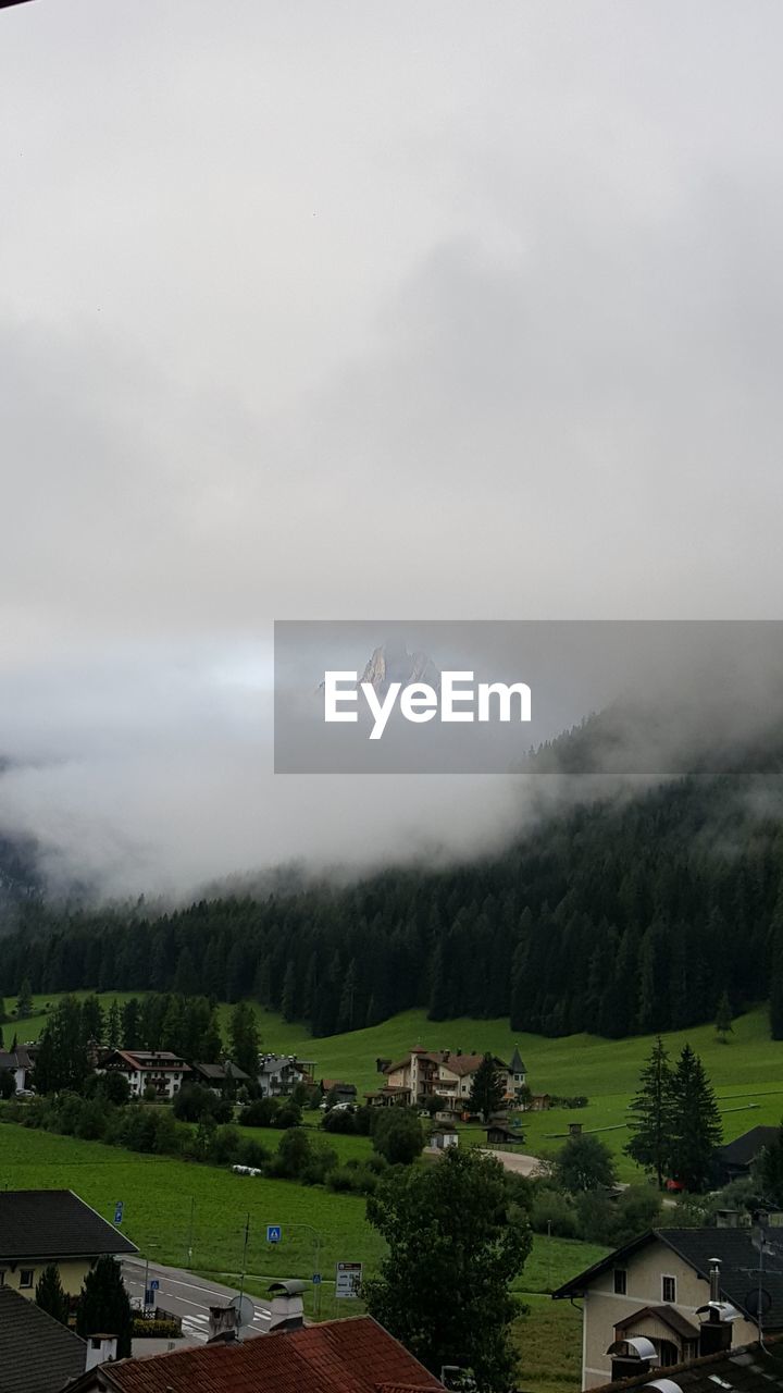 Scenic view of landscape and houses against sky