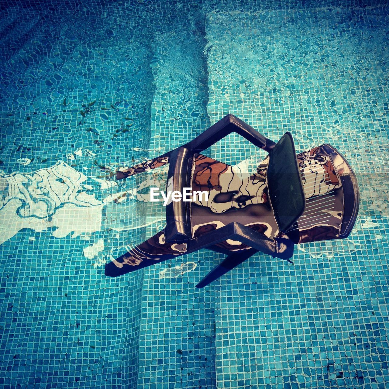 High angle view of chair in swimming pool