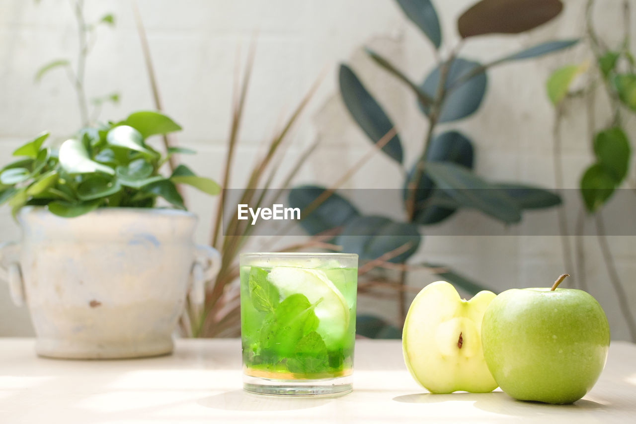 GREEN FRUITS IN PLATE ON TABLE