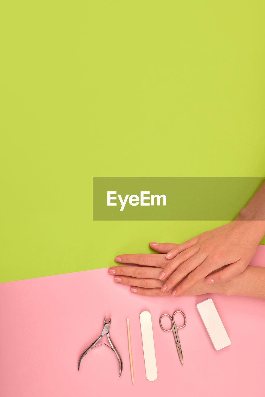 Female hands with beautiful manicure on color background