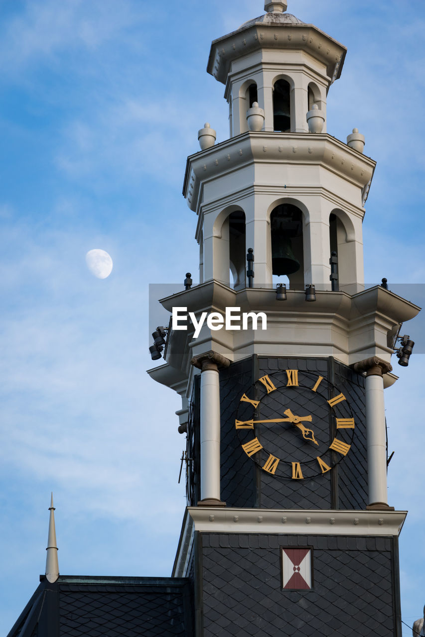 Low angle view of bell tower against sky