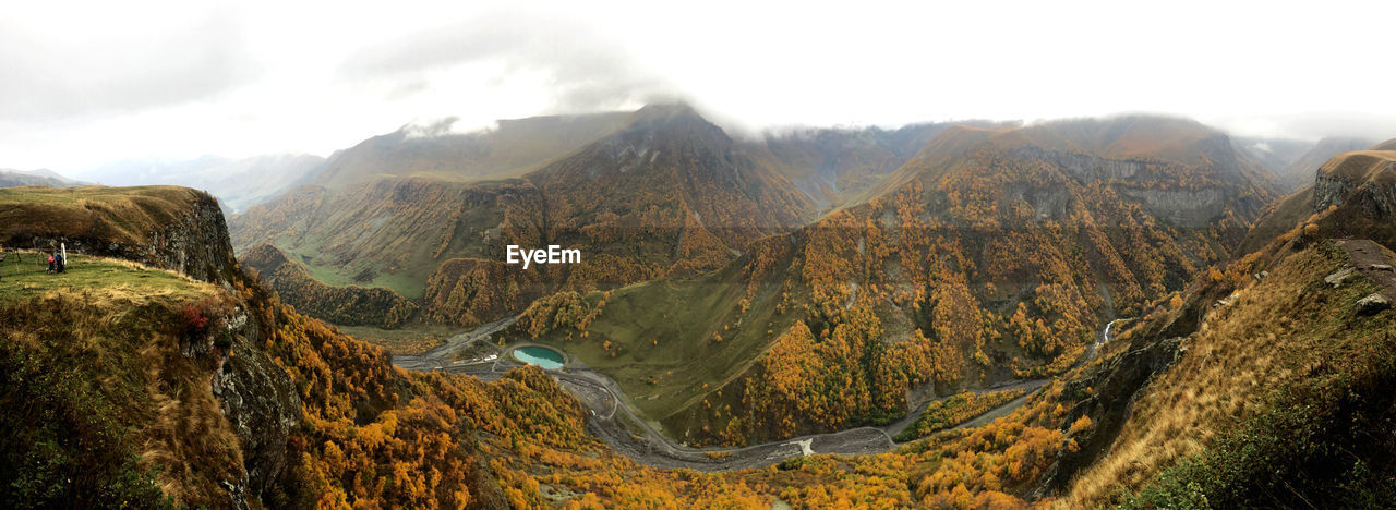 Panoramic view of valley and mountains against sky