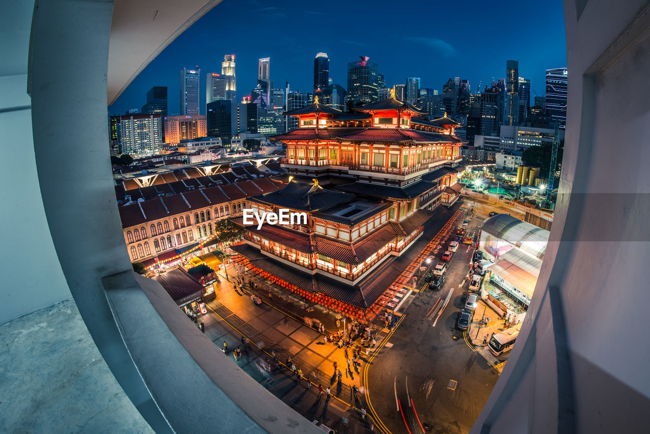 High angle view of illuminated cityscape against sky at night