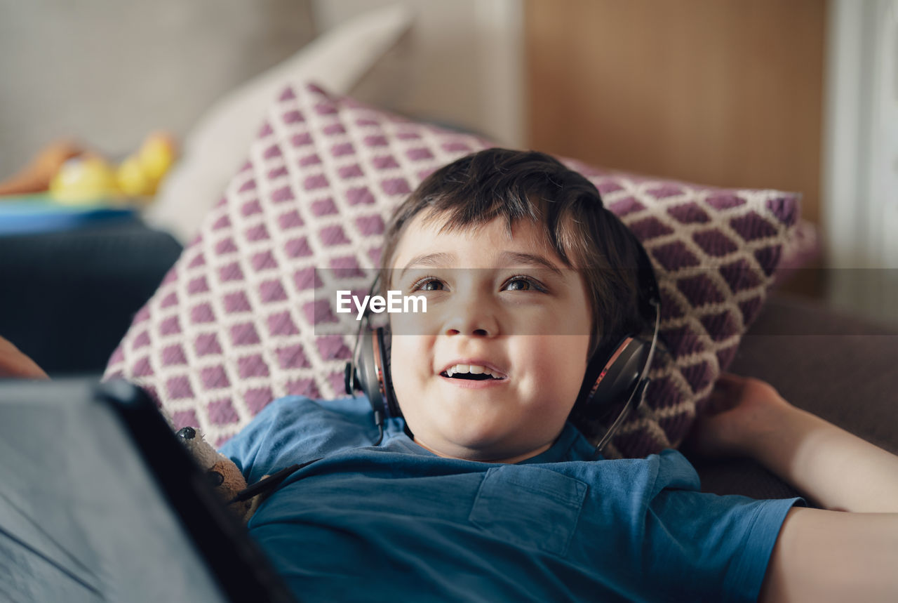 Portrait of boy on bed at home