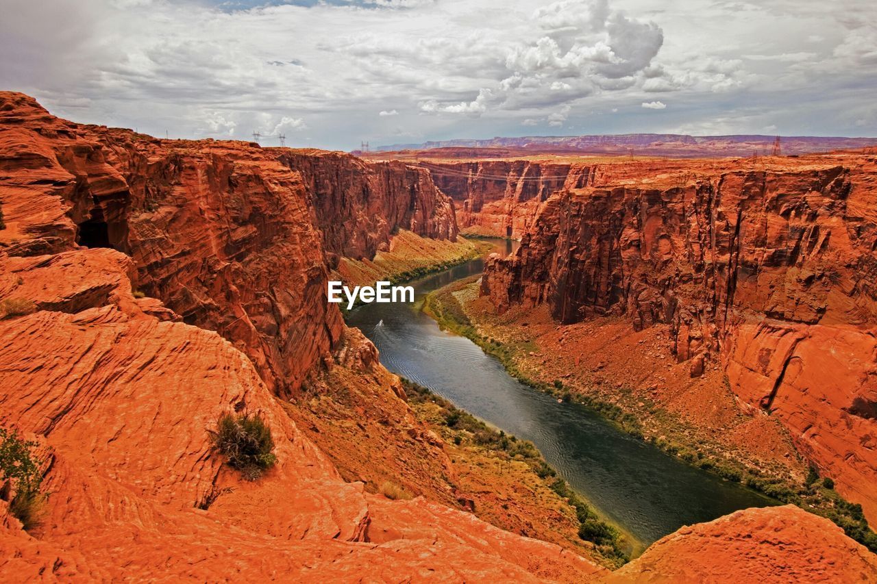 Lake powell amidst rock formation against sky