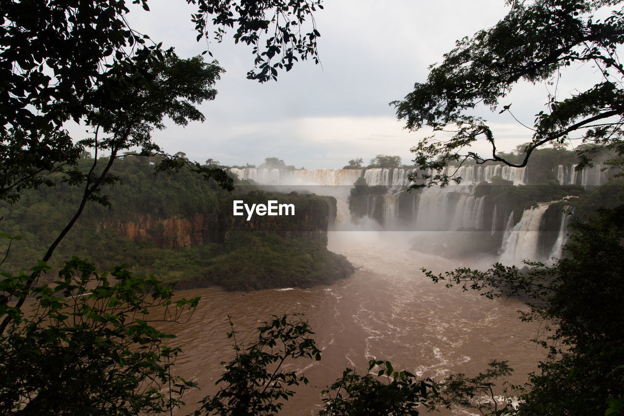 PANORAMIC SHOT OF WATERFALL AGAINST SKY