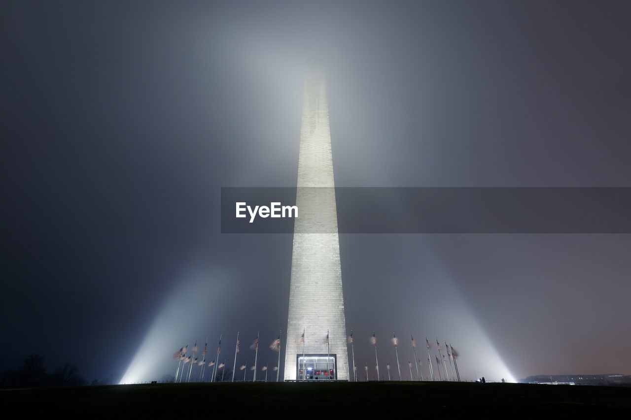 LOW ANGLE VIEW OF ILLUMINATED BUILDING AGAINST SKY