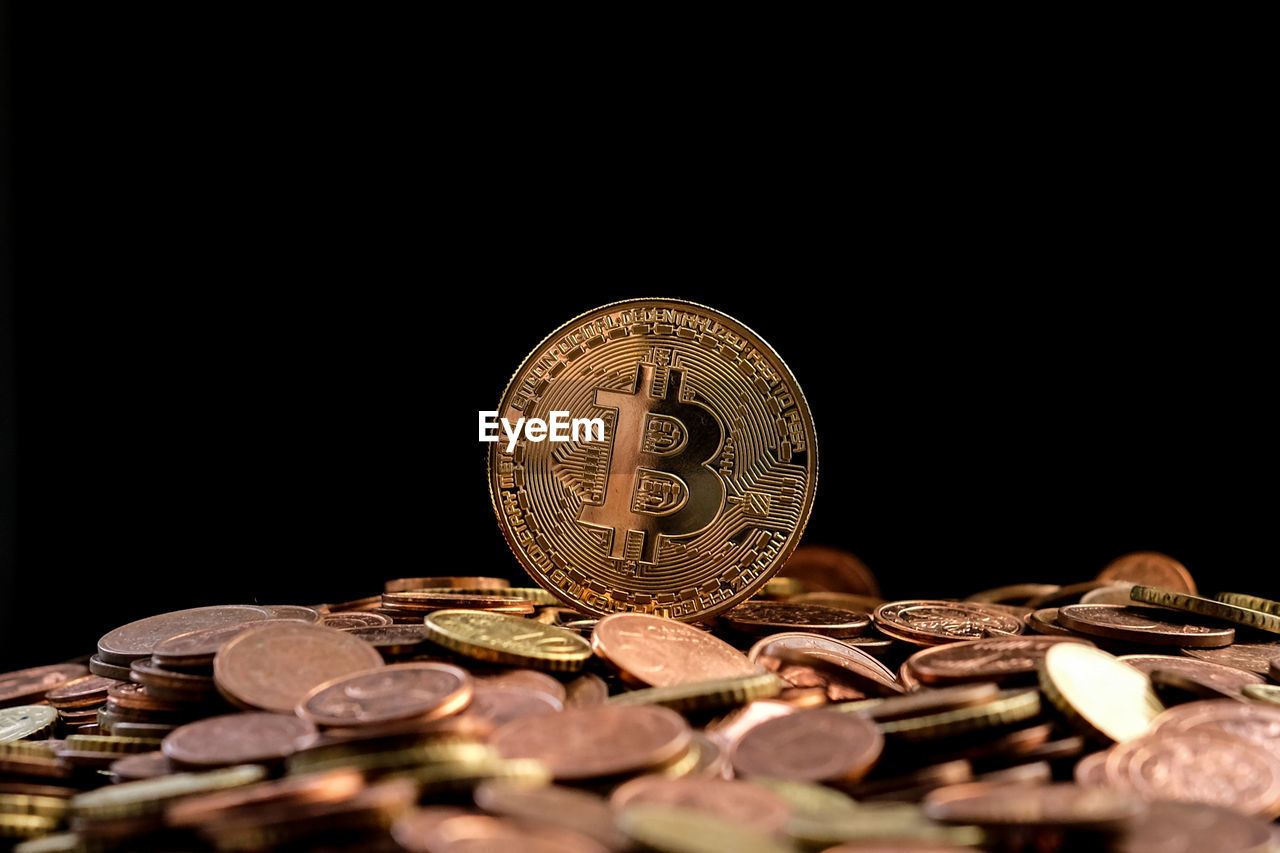 CLOSE-UP OF COINS WITH BLACK BACKGROUND