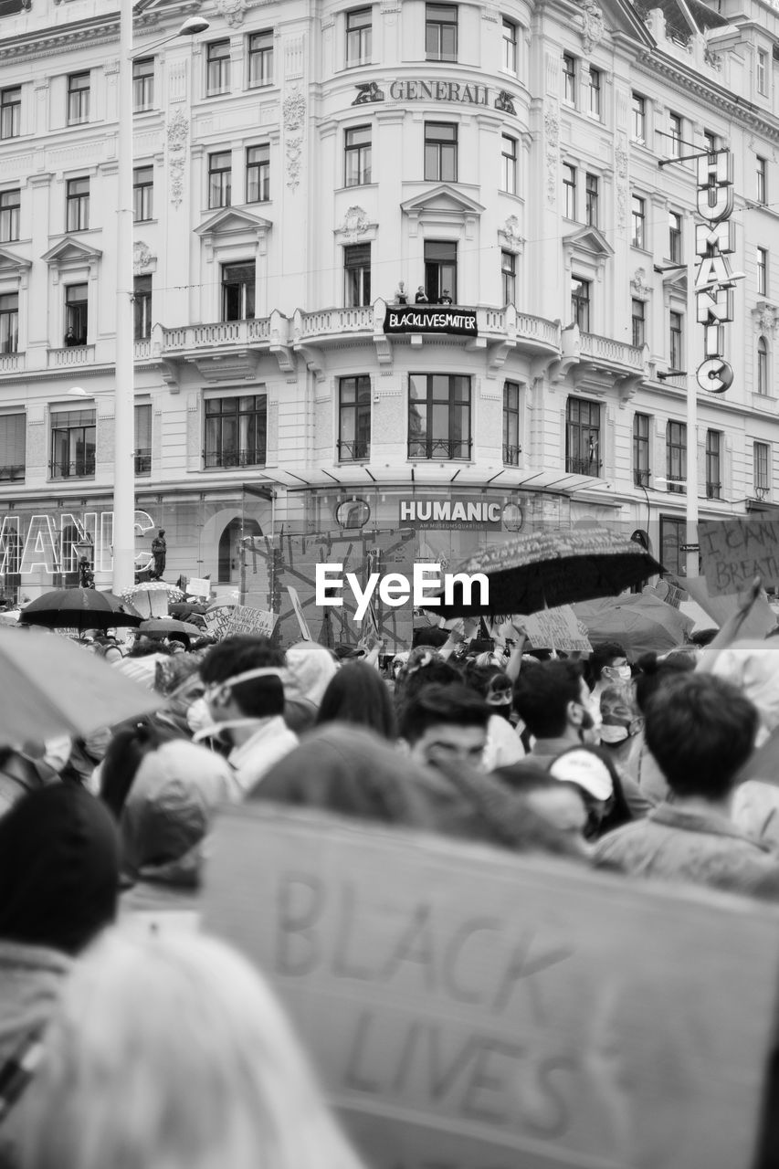 GROUP OF PEOPLE IN FRONT OF BUILDING