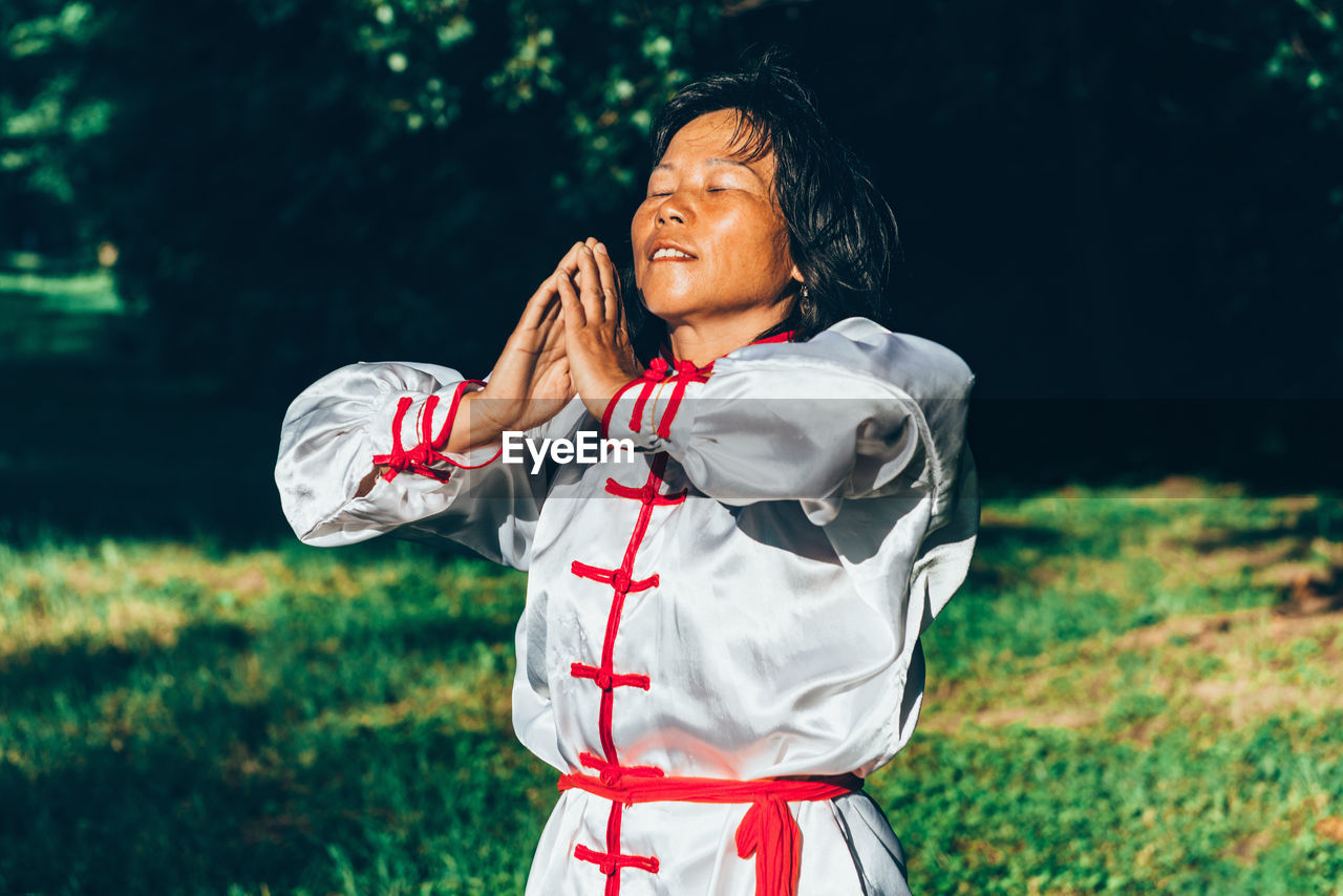 Mature woman practicing martial arts at park