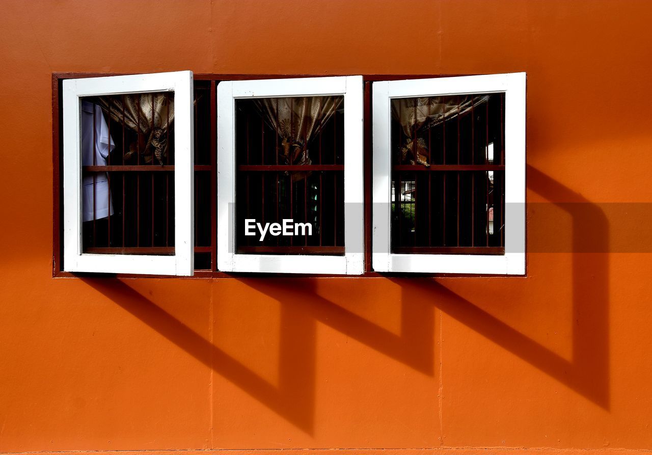 architecture, window, no people, building exterior, built structure, wall, wall - building feature, art, sunlight, orange color, building, shadow, picture frame, day, nature, outdoors, interior design, wood