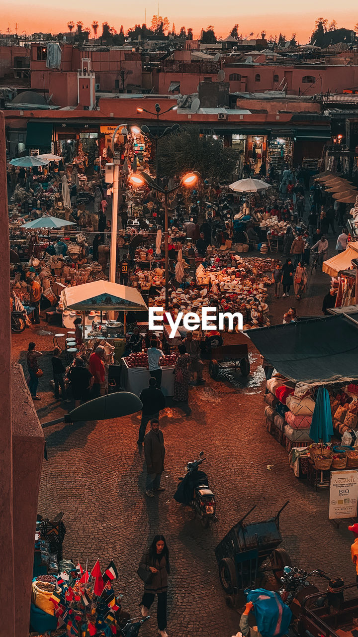 HIGH ANGLE VIEW OF PEOPLE AT MARKET IN CITY